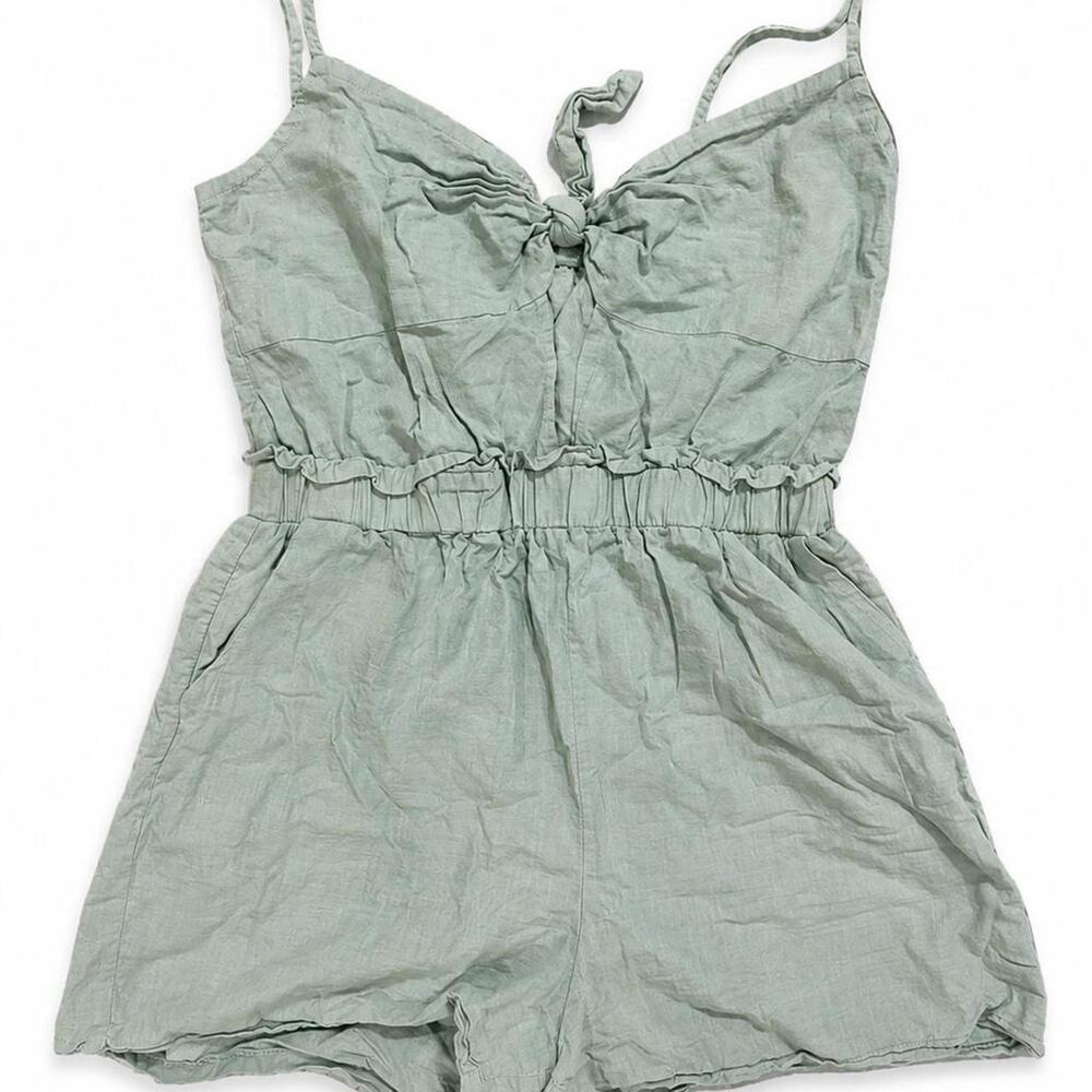 Green linen romper with tie front and adjustable straps